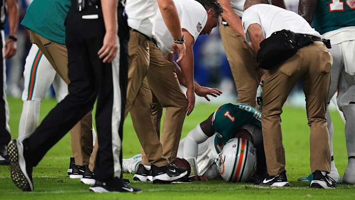 Sep 12, 2024; Miami Gardens, Florida, USA; A members of the Miami Dolphins training staff attend to quarterback Tua Tagovailoa (1) after an apparent injury during the second half against the Buffalo Bills at Hard Rock Stadium. Mandatory Credit: Jasen Vinlove-Imagn Images Sep 12, 2024; Miami Gardens, Florida, USA; A members of the Miami Dolphins training staff attend to quarterback Tua Tagovailoa (1) after an apparent injury during the second half against the Buffalo Bills at Hard Rock Stadium. Mandatory Credit: Jasen Vinlove-Imagn Images