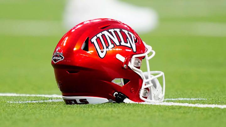 A UNLV Rebels helmet sits on the field during the second half of a game between the UNLV Rebels and the Hawaii Warriors at Allegiant Stadium on September 30, 2023 in Las Vegas, Nevada. Rebels defeat the Warriors 44-20. A UNLV Rebels helmet sits on the field during the second half of a game between the UNLV Rebels and the Hawaii Warriors at Allegiant Stadium on September 30, 2023 in Las Vegas, Nevada. Rebels defeat the Warriors 44-20.