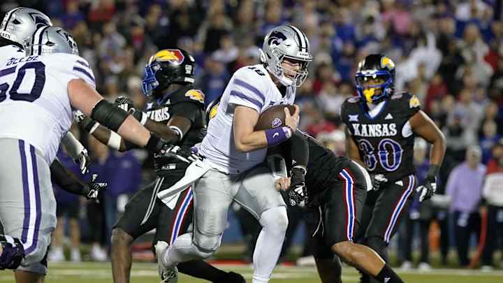 Nov 18, 2023; Lawrence, Kansas, USA; Kansas State Wildcats quarterback Will Howard (18) runs the Nov 18, 2023; Lawrence, Kansas, USA; Kansas State Wildcats quarterback Will Howard (18) runs the