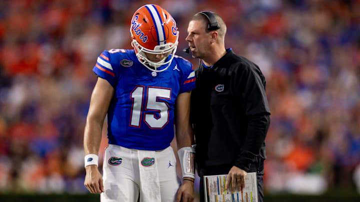 Florida Gators head coach Billy Napier and Florida Gators quarterback Graham Mertz (15) talk during a timeout in their game against Georgia. Florida Gators head coach Billy Napier and Florida Gators quarterback Graham Mertz (15) talk during a timeout in their game against Georgia.