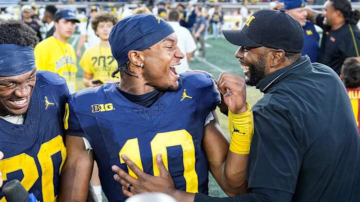 Michigan head coach Sherrone Moore, right, talks to quarterback Alex Orji (10) and running back Kalel Mullings (20) after 27-24 win over USC at Michigan Stadium in Ann Arbor on Saturday, Sept. 21, 2024. Michigan head coach Sherrone Moore, right, talks to quarterback Alex Orji (10) and running back Kalel Mullings (20) after 27-24 win over USC at Michigan Stadium in Ann Arbor on Saturday, Sept. 21, 2024.