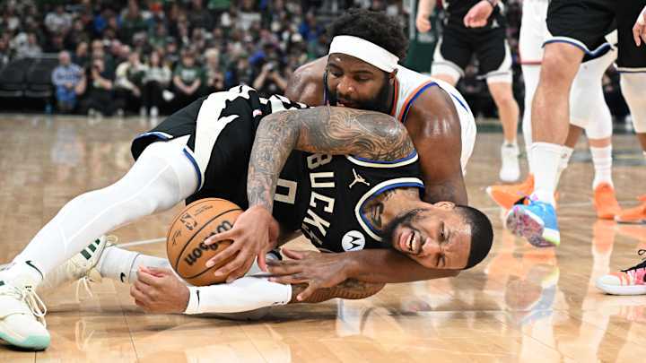 Apr 7, 2024; Milwaukee, Wisconsin, USA; Milwaukee Bucks guard Damian Lillard (0) and New York Knicks center Mitchell Robinson (23) battle for a loose ball in the first half at Fiserv Forum. Mandatory Credit: Michael McLoone-Imagn Images Apr 7, 2024; Milwaukee, Wisconsin, USA; Milwaukee Bucks guard Damian Lillard (0) and New York Knicks center Mitchell Robinson (23) battle for a loose ball in the first half at Fiserv Forum. Mandatory Credit: Michael McLoone-Imagn Images