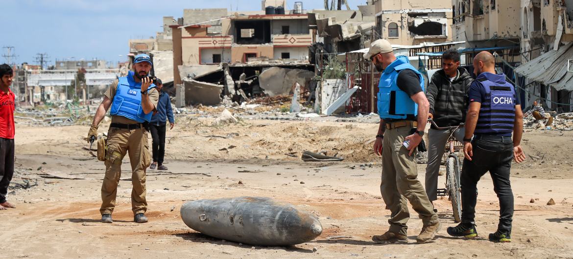A UN team inspects an unexploded 1,000-pound bomb lying on a main road in Khan Younis, Gaza.. A UN team inspects an unexploded 1,000-pound bomb lying on a main road in Khan Younis, Gaza..