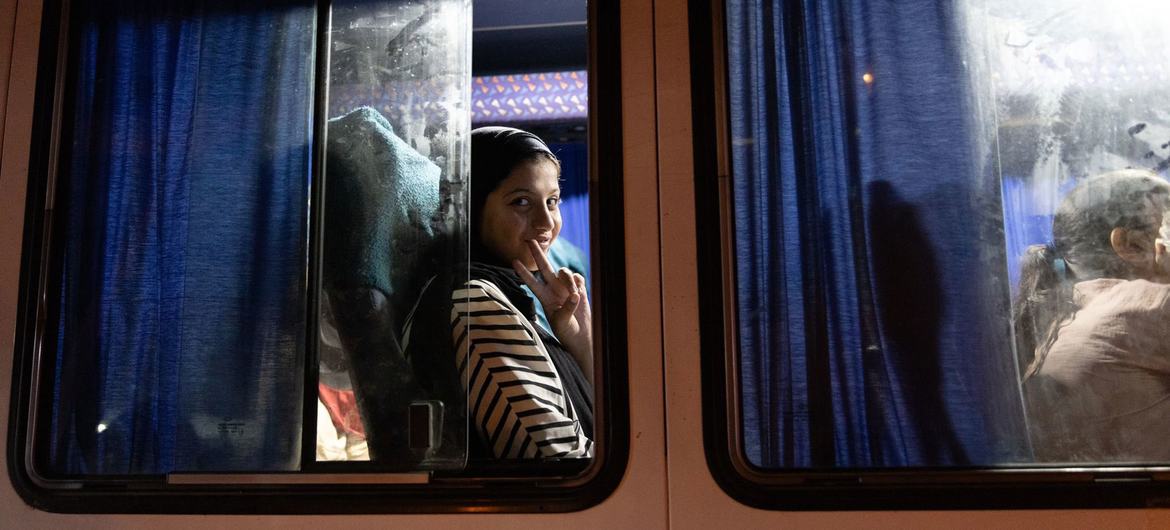 One of the 85 sick and severely injured patients evacuated from Gaza to United Arab Emirates waves from the bus. One of the 85 sick and severely injured patients evacuated from Gaza to United Arab Emirates waves from the bus.