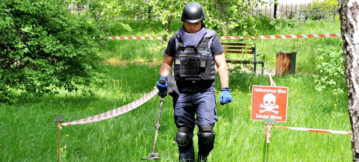 A deminer for the State Emergency Service of Ukraine sweeps the ground for unexploded ordnance and landmines. A deminer for the State Emergency Service of Ukraine sweeps the ground for unexploded ordnance and landmines.