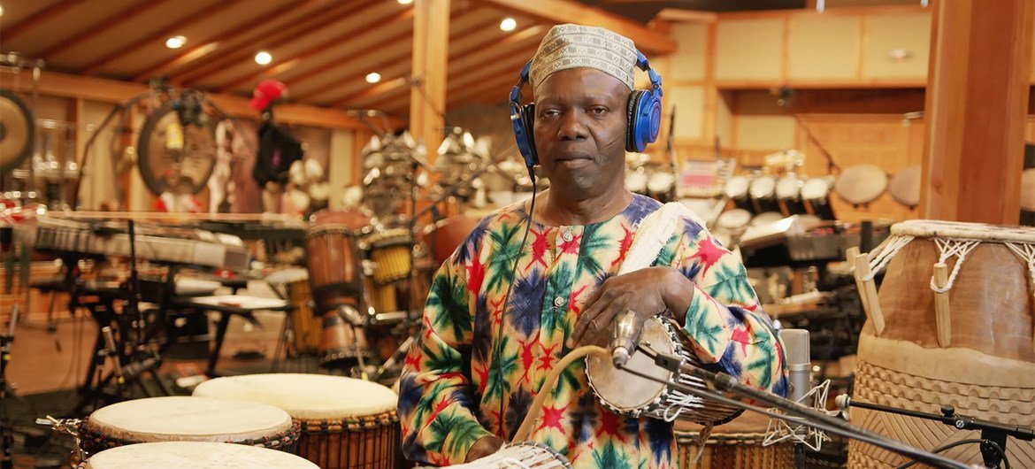 Nigerian percussionist Sikiru Adepoju performing "King Clavé", a collaboration between Playing For Change and Planet Drum. Nigerian percussionist Sikiru Adepoju performing "King Clavé", a collaboration between Playing For Change and Planet Drum.