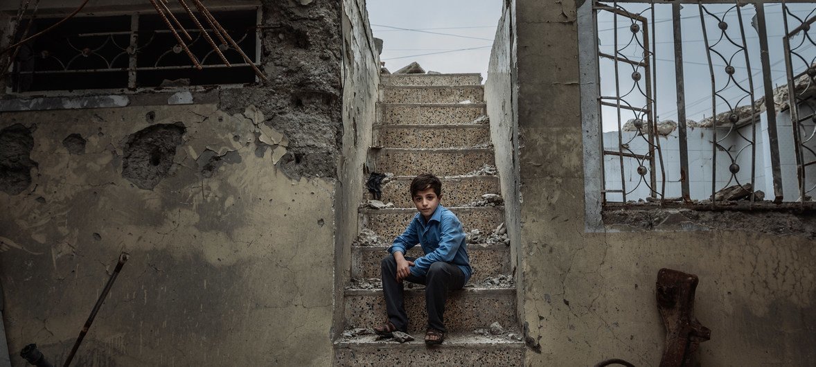 Mohammed, 10, sits on the staircase of the former house he used to hide with his family in Mosul. Mohammed, 10, sits on the staircase of the former house he used to hide with his family in Mosul.