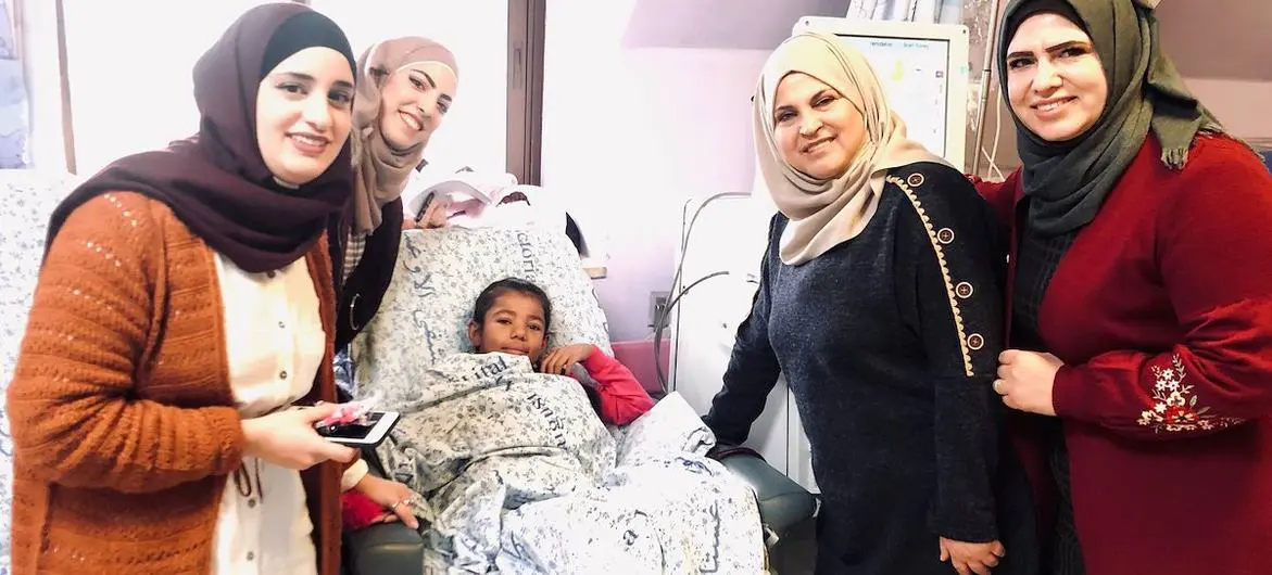 Shahd, 11, with her Determination School teachers in Augusta Victoria hospital, Palestine.