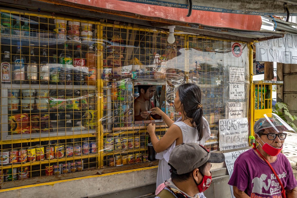 A woman buys at a kiosk in the coastal village of Talaba Dos on September 16, 2021 in Bacoor, Cavite province, Philippines. A woman buys at a kiosk in the coastal village of Talaba Dos on September 16, 2021 in Bacoor, Cavite province, Philippines.