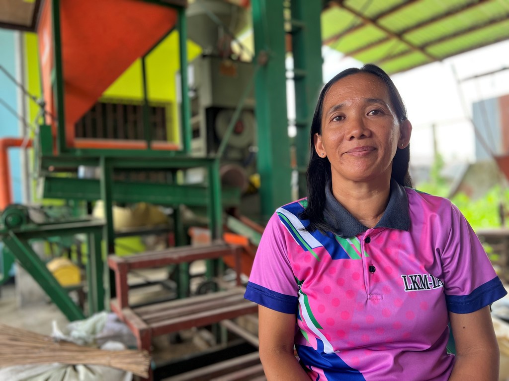 Marcializa Calud stands in front of the new rice milling machine. Marcializa Calud stands in front of the new rice milling machine.