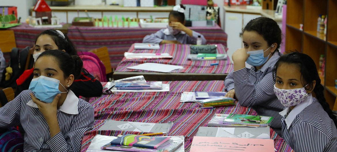 Students wear face masks at a school in the Far'a refugee camp in the West Bank. Students wear face masks at a school in the Far'a refugee camp in the West Bank.