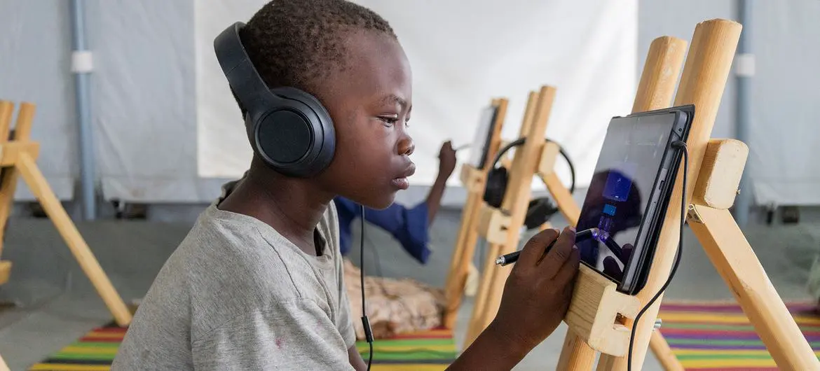 Children participate in an e-learning session at the Al Seniyaa internally displaced people’s gathering site in Port Sudan.