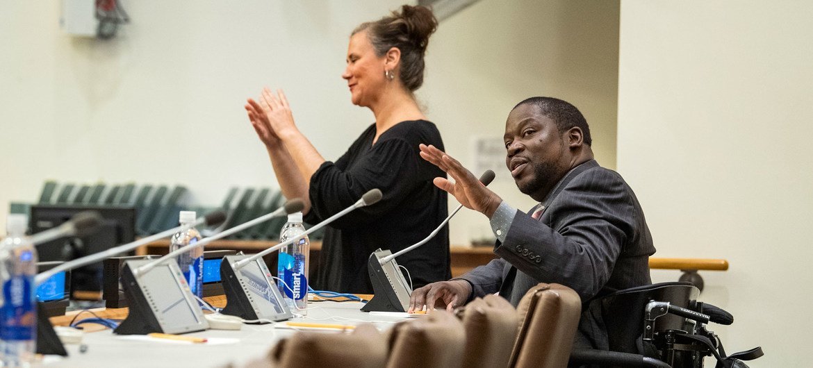 A sign language interpreter translates for actor Daryl Mitchell (seated) during a special event at the UN. A sign language interpreter translates for actor Daryl Mitchell (seated) during a special event at the UN.