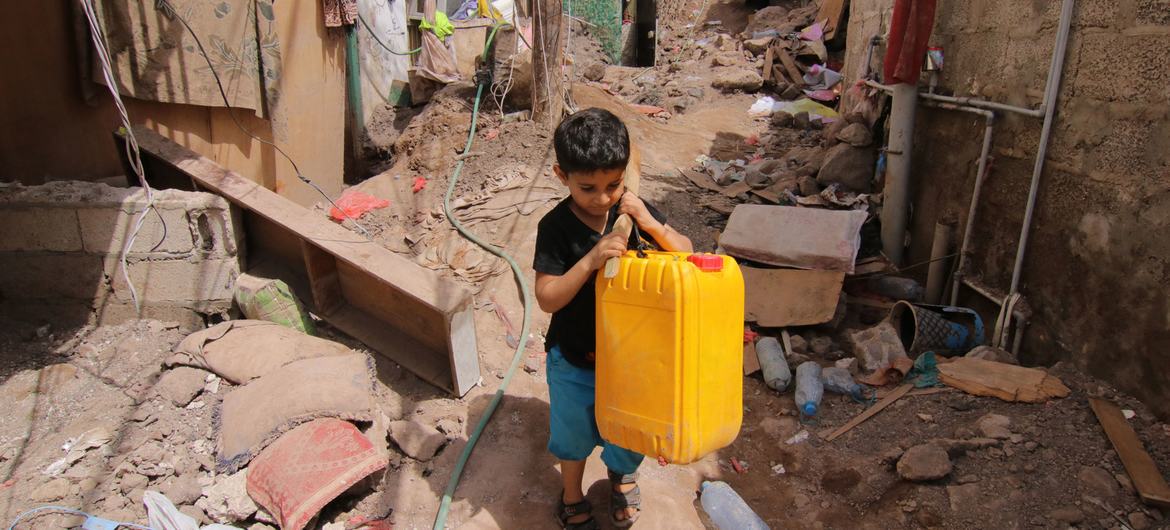 A boy is photographed carrying a water container in the Ala’amaseer area of the city of Aden, Yemen, on 29 April 2020. A boy is photographed carrying a water container in the Ala’amaseer area of the city of Aden, Yemen, on 29 April 2020.