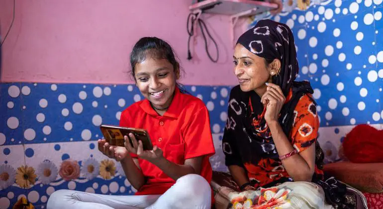 A mother helps her daughter with online studies while schools are shut during COVID-19 in India. (file)