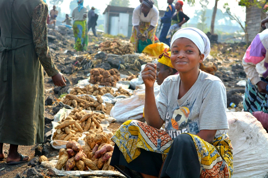 A woman sells food at a market in the Democratic Republic of the Congo. A woman sells food at a market in the Democratic Republic of the Congo.