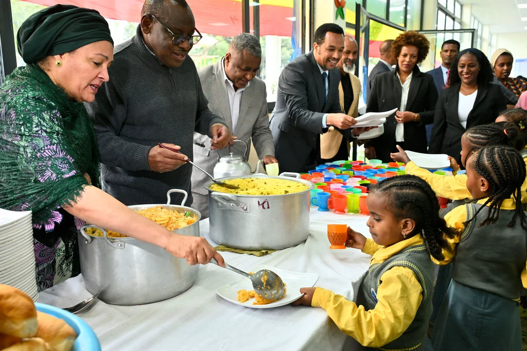 UN Deputy Secretary-General Amina Mohammed (left) serves food to children at a UN Food Systems Summit event in Addis Ababa, Ethiopia.