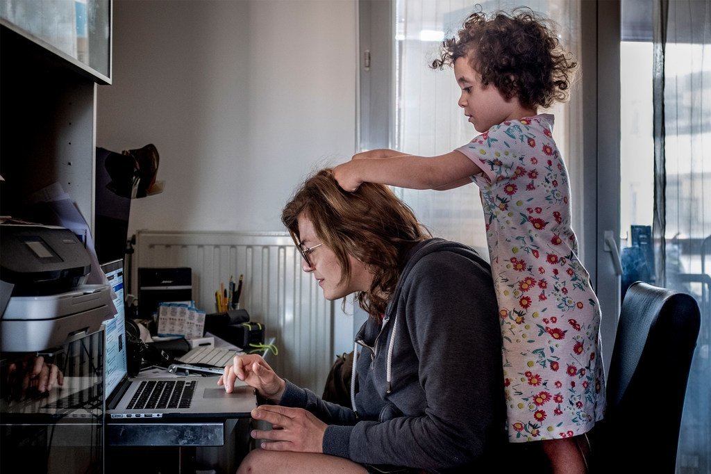 Lyon, France, March 19, lockdown day 3. Anne-Lise, journalist, teleworking for TV channel Euronews with 3-year-old daughter Violette keeping close. Lyon, France, March 19, lockdown day 3. Anne-Lise, journalist, teleworking for TV channel Euronews with 3-year-old daughter Violette keeping close.