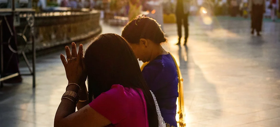 Two women pray at a temple in Yangon, Myanmar. (file photo)
