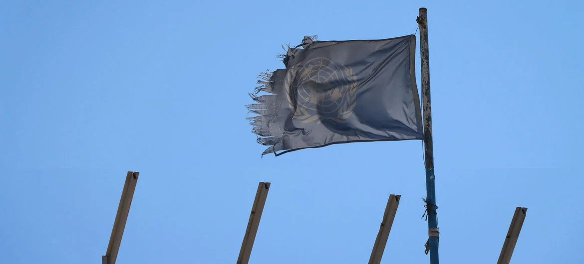 A shredded UN flag flies over a destroyed school building in Khan Younis.