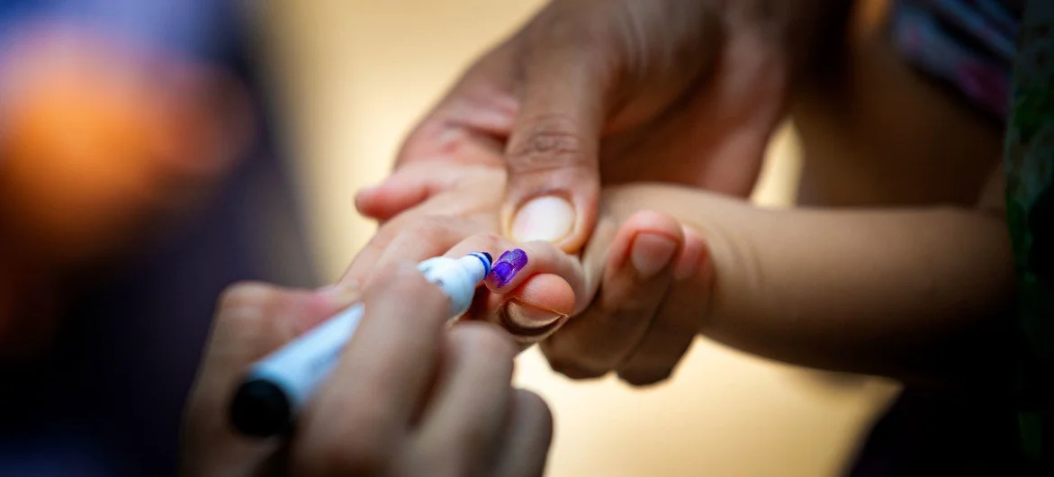 In Lahore, Pakistan, a health worker marks a baby's finger to show she has received the polio vaccine. In Lahore, Pakistan, a health worker marks a baby's finger to show she has received the polio vaccine.