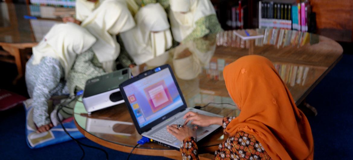 Girls attend a science class at a school in Indonesia. Girls attend a science class at a school in Indonesia.