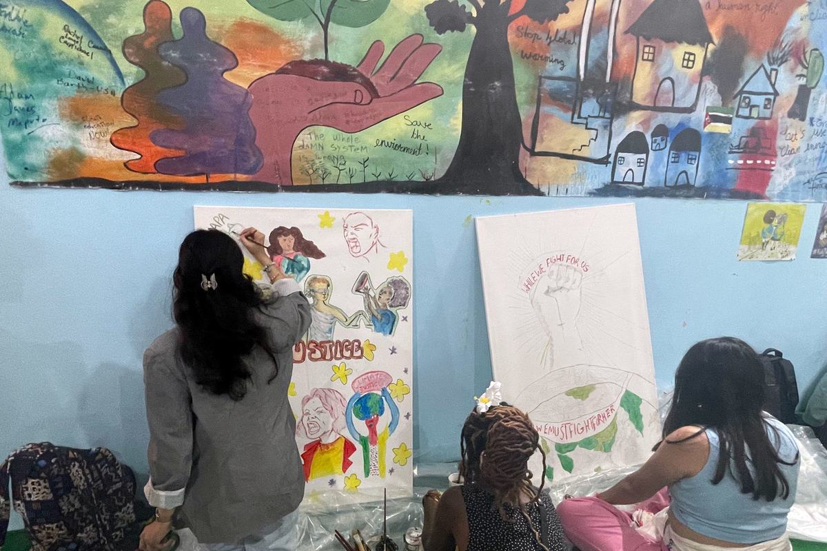 UNICEF youth advocate Ayshka Najib paints a collaborative artwork at the youth pavilion. UNICEF youth advocate Ayshka Najib paints a collaborative artwork at the youth pavilion.