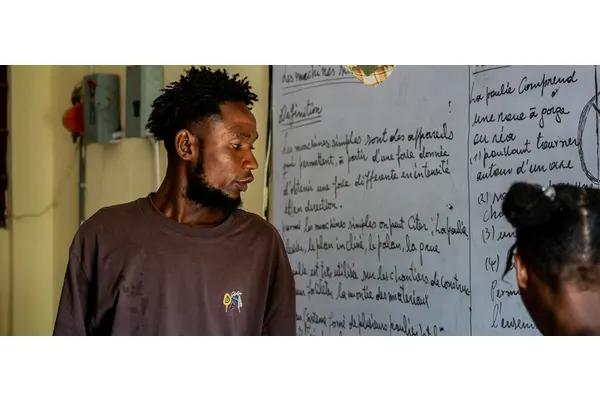 Desks become beds as Haitian school shelters people displaced by violence | UN News