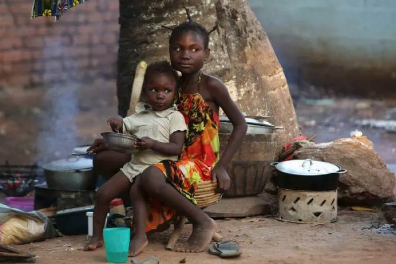 Children have a meal in a camp for internally displaced people on the grounds of the Saint Sauveur church in the capital Bangui, Central African Republic. Credit: Siegfried Modola/Reuters