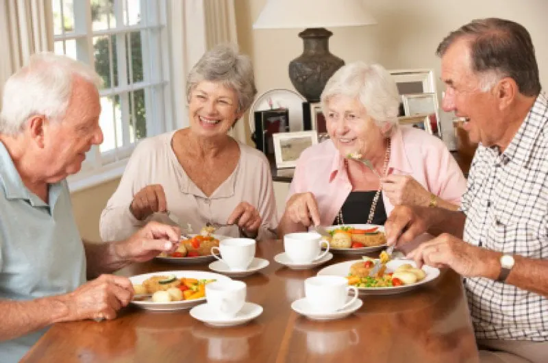 Group Of Senior Couples Enjoying Meal Together Group Of Senior Couples Enjoying Meal Together