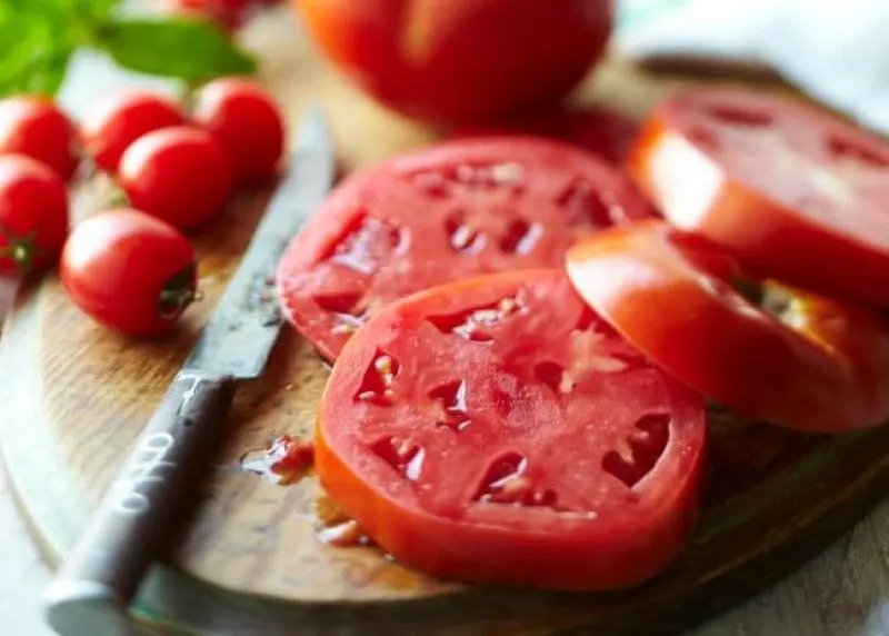 Sliced tomato on cutting board Photo by Meredith Sliced tomato on cutting board Photo by Meredith