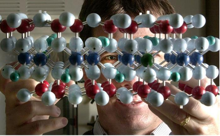 Cliff Johnston, professor of agronomy in the College of Agriculture and earth, atmospheric, and planetary sciences in the College of Science at Purdue University, looks through a clay molecular structure.