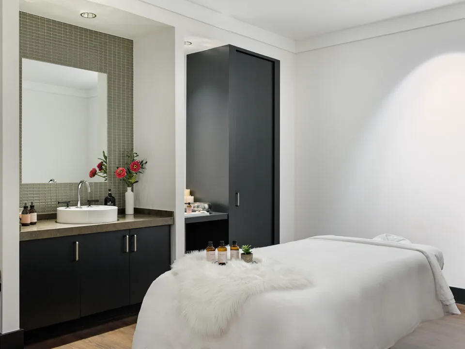 white spa room with a massage table