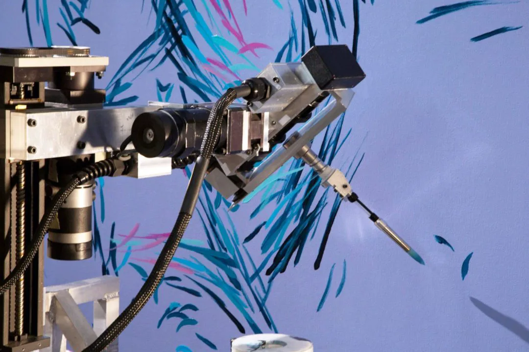 robot paints blue brush stroked on canvas