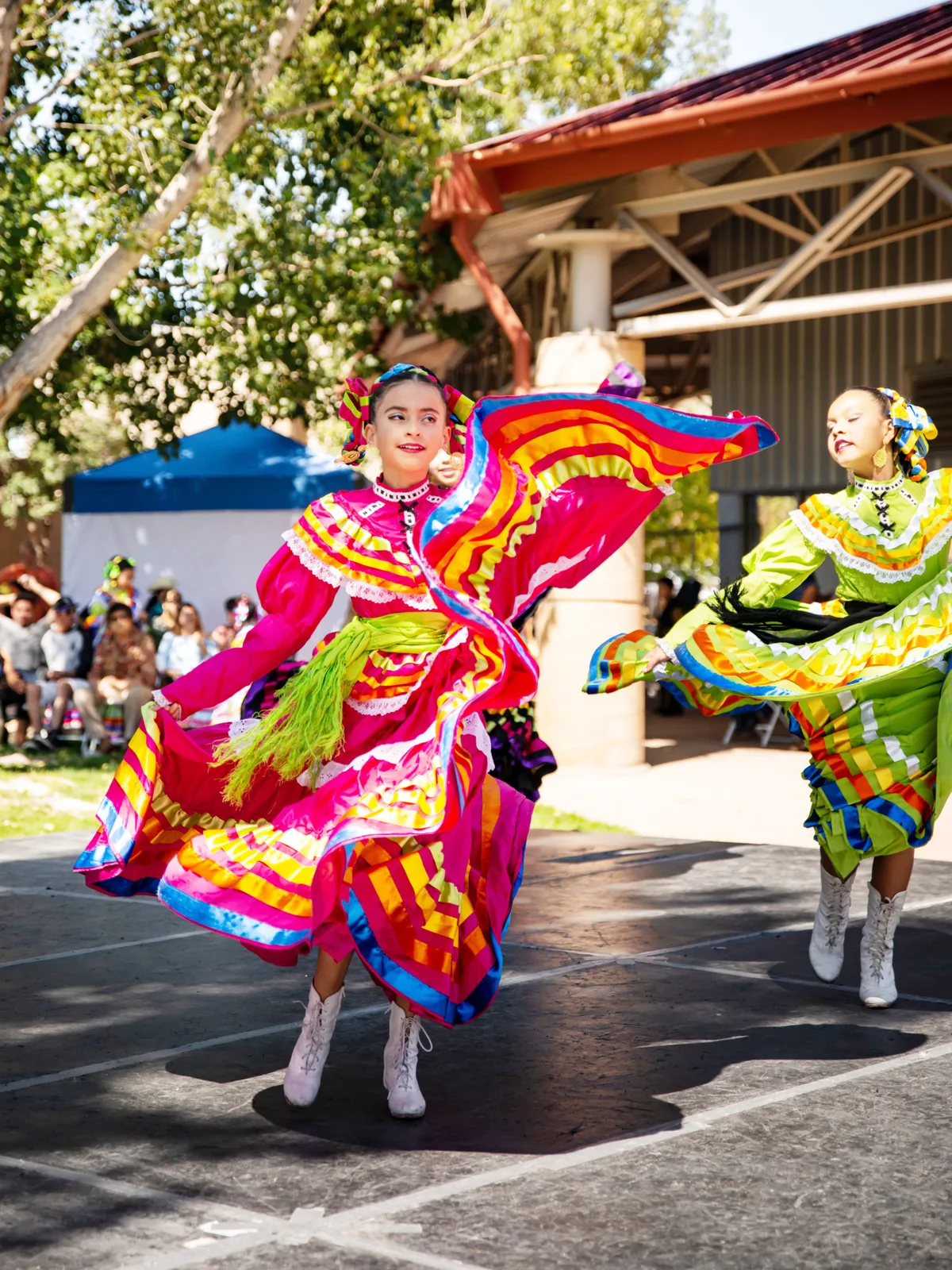A dancer wearing a pink dress at the El Pueblo History Museum