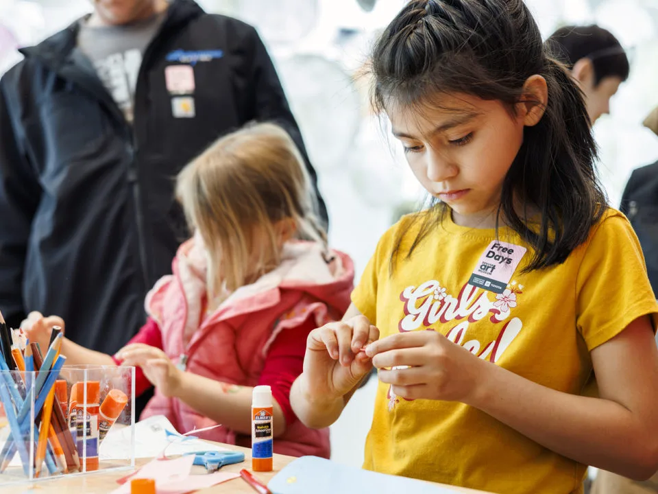 A girl does an art project for Día del Niño at the Denver Art Museum