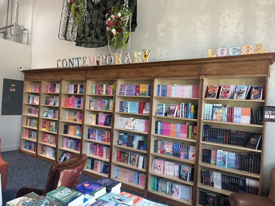 Wall of bookshelves with "Contemporary" and "Local" sections