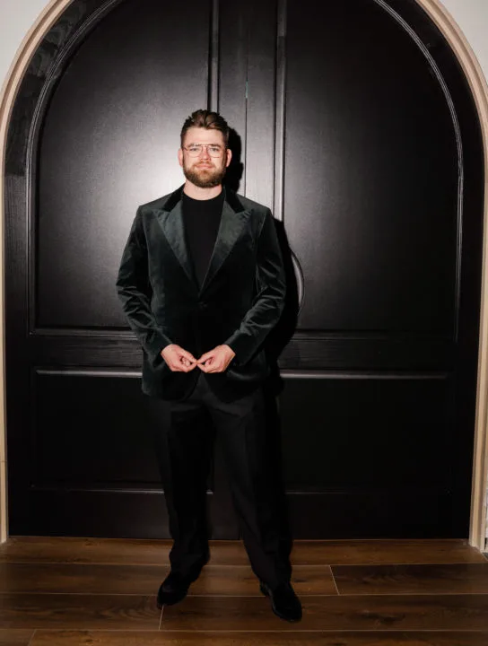 Arend Richard stands in front of the doors to Cirrus Social Lounge
