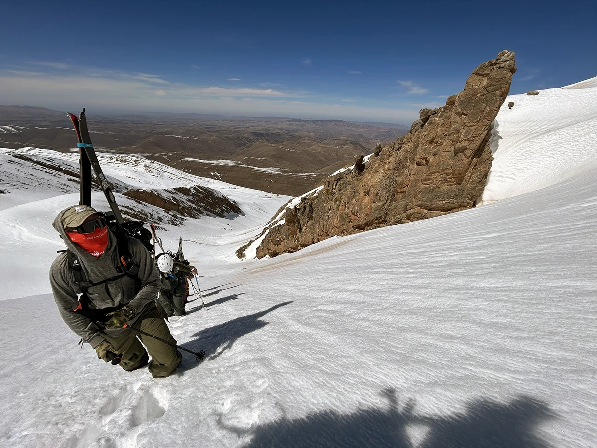 A screen grab of a man climbing a snowy slope in Africa from “Big Mountain Soul: Ski Africa”