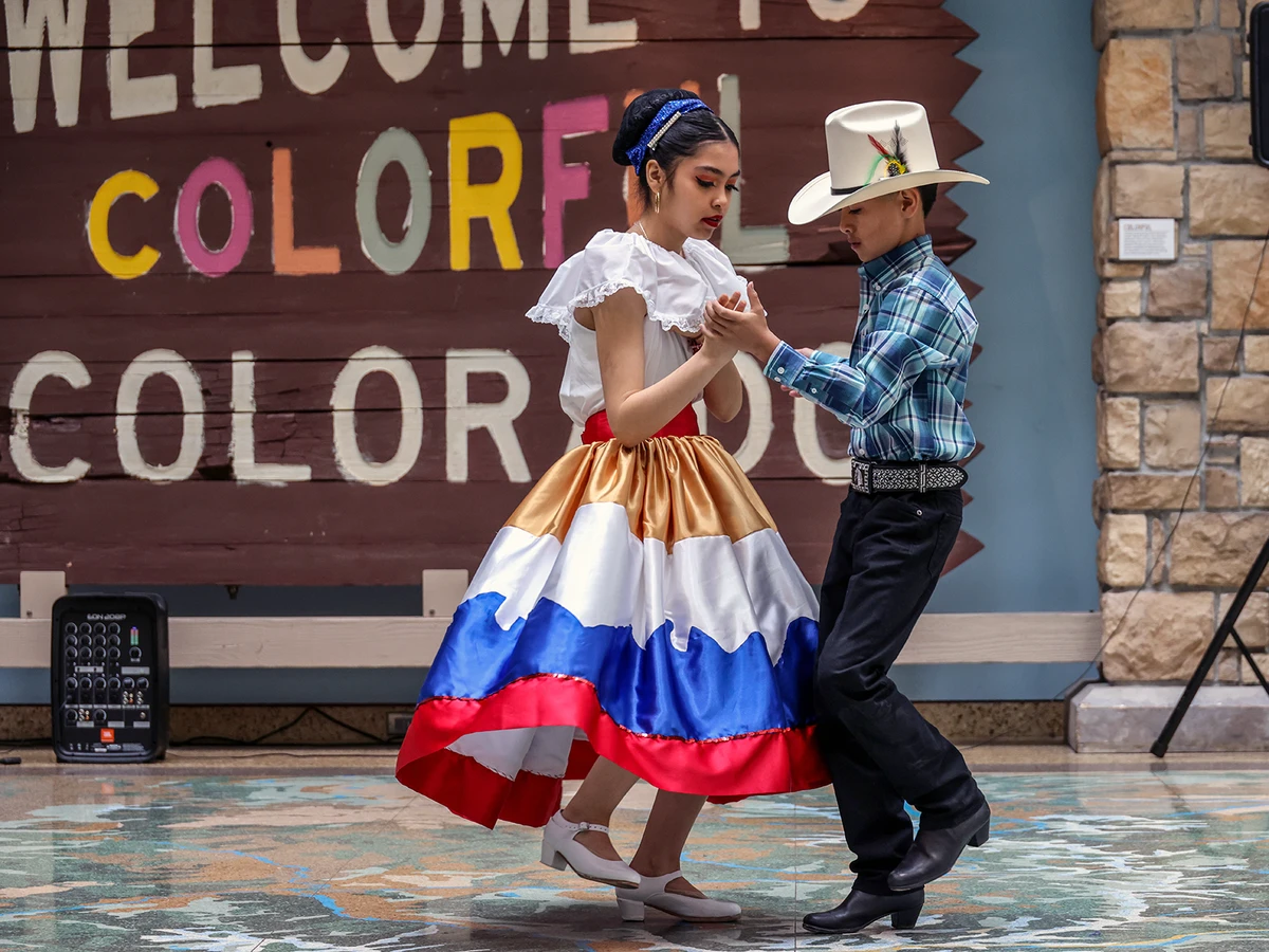 Two kids perform a traditional dance for Día del Niño at History Colorado
