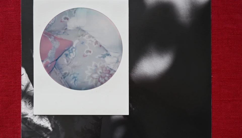 A small image of an unmade bed over a larger indistinguishable image