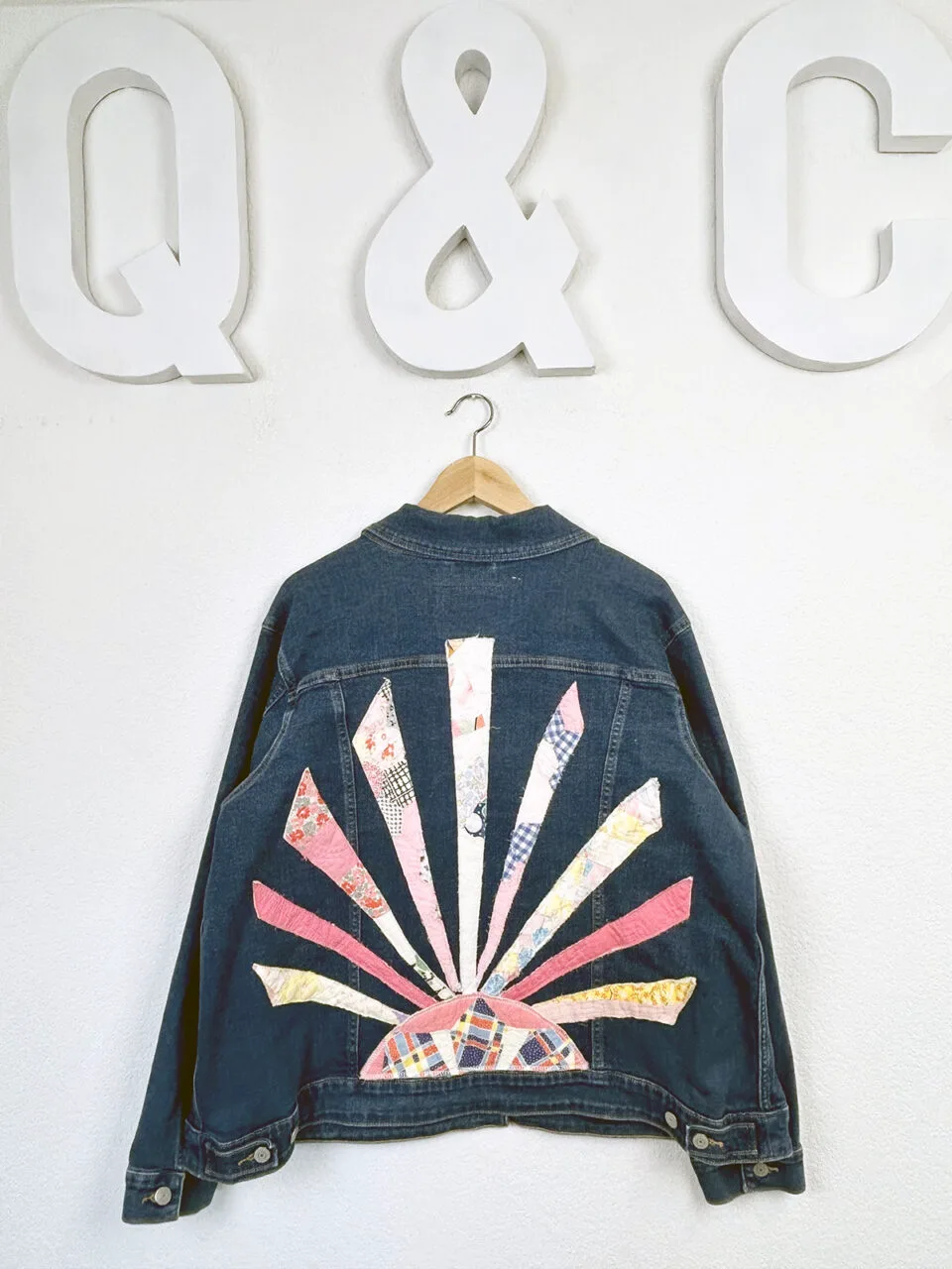 A denim jacket with a quilted pattern on the back