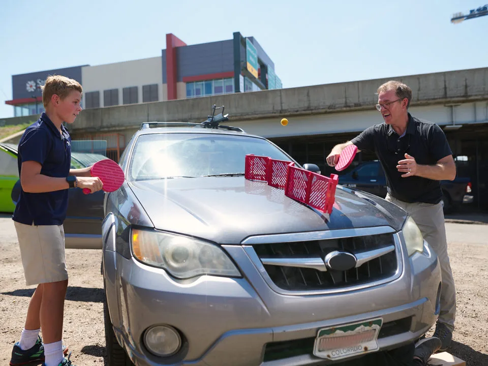 Pepper Pong set up on the hood of a car