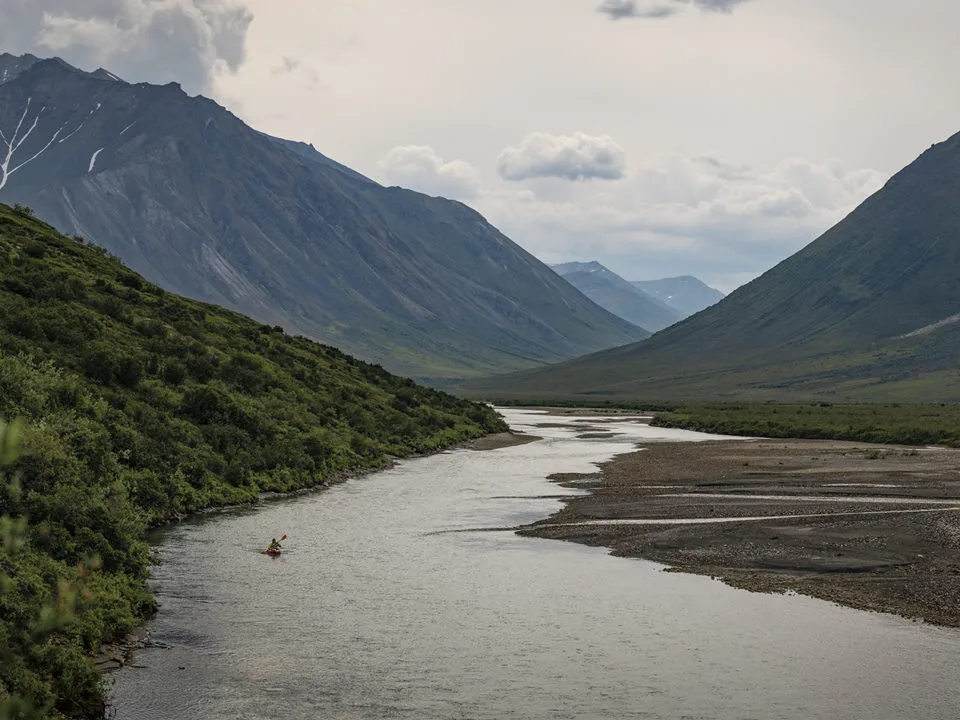 A person paddles down the Noatak River in Alaska