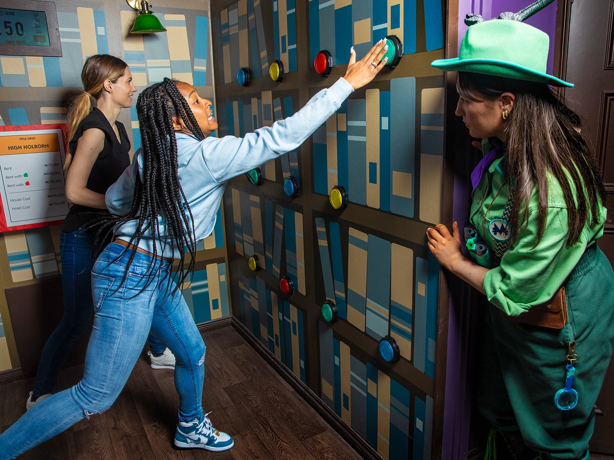 A girl presses a button in Monopoly Lifesized