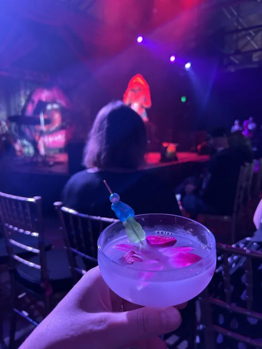The Midnight Radio in a coupe glass with a gummy bear garnish
