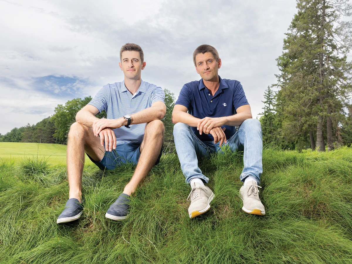 two men sitting on ground
