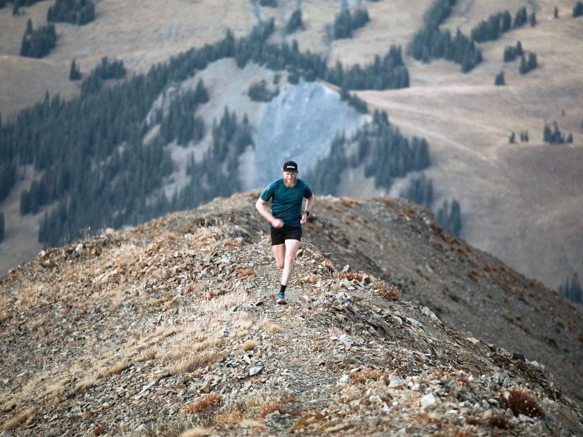 Drew Petersen runs along a rocky ridge