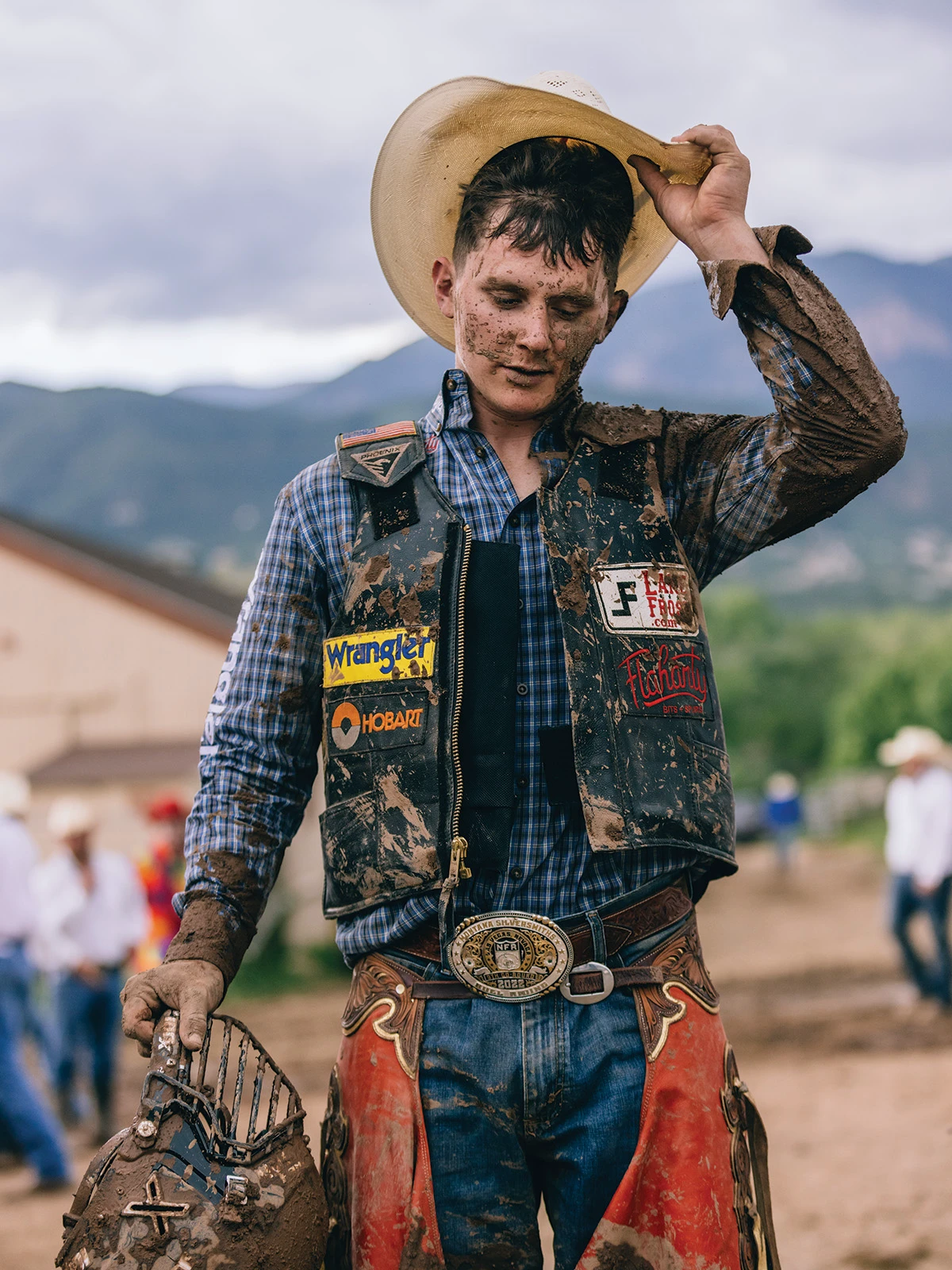 cowboy holding hat
