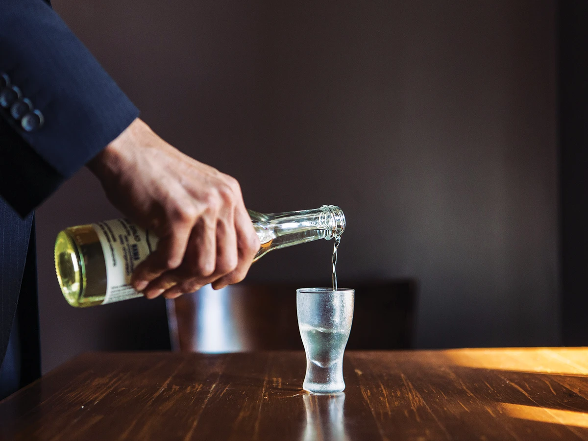 Hand pouring sake